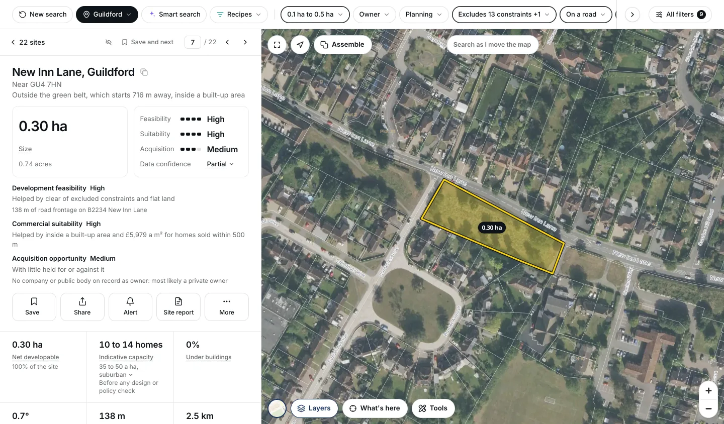 New Inn Lane, Guildford, open over aerial photography: 0.30 hectares of grass between the road and houses, outlined in yellow, with High feasibility and suitability, 138 metres of road frontage, homes nearby selling for 5,979 pounds a square metre, and an estimate of 10 to 14 homes.